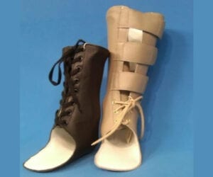 Two different orthopedic foot braces on a blue background.